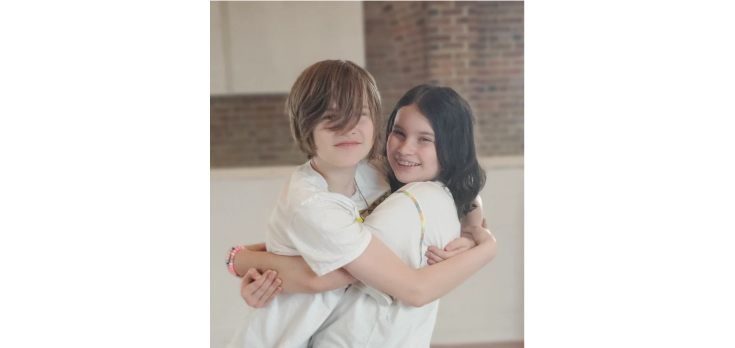 Two children smiling together at WePickle event